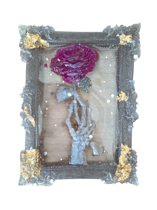 Large skeleton hand holding a rose (ornament)