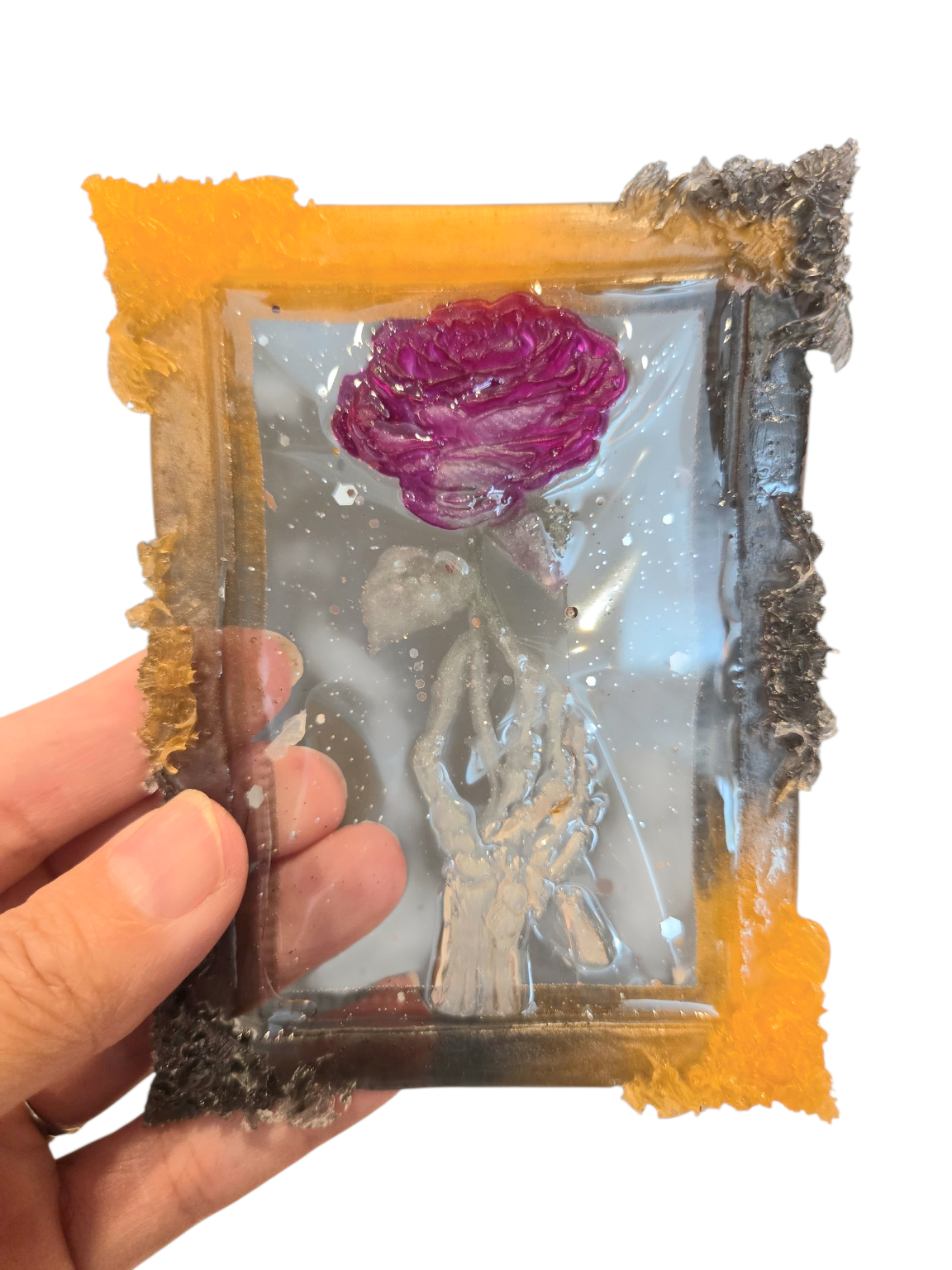 Large skeleton hand holding a rose (ornament)